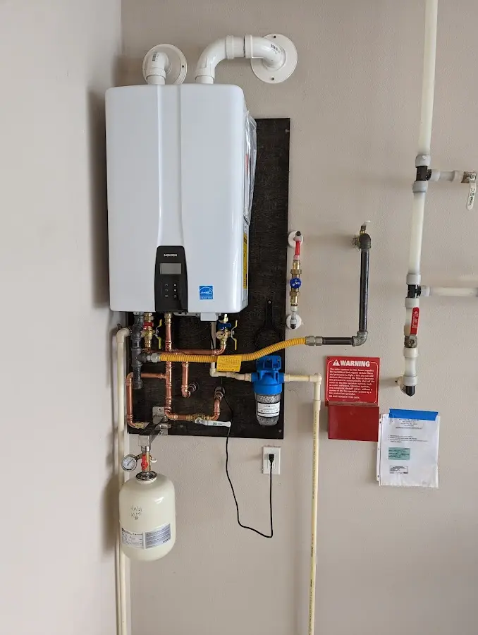 Professional plumber installing copper piping in a Bayou Blue home